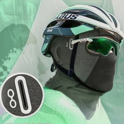 A grey balaclava cycling face mask worn with a cycling helmet and sunglasses, featuring a logo.