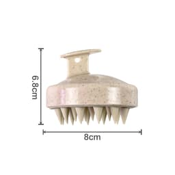 A hair scalp massager in a light brown shade with speckles and multiple pointed bristles for stimulation.