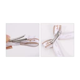 A hair clip bow with a white and brown patterned ribbon and a silver clip. The design features a double loop.