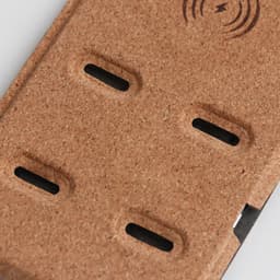A 10W stand wireless charger featuring a cork surface and black rubber grips for stability. It includes a branding logo.
