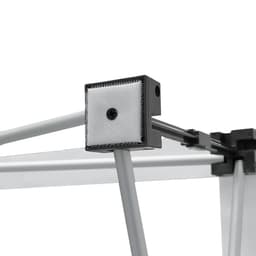 A close-up of a fabric popup display frame, featuring grey metal components and a textured connector.