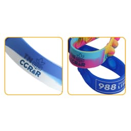Colourful silicone wristbands with varied designs, featuring different blue shades and a logo.