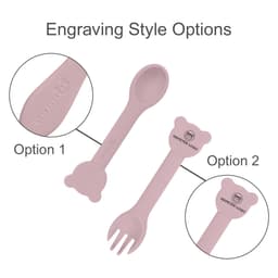 A pink silicone kids cutlery set featuring a spoon and fork with bear-shaped handles, displaying engraving style options.