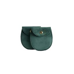 A pair of oval velvet jewelry pouches in dark green, featuring a button closure and a stitched edge.
