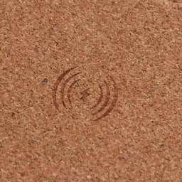 A square cork wireless charger with a subtle design on the surface, showcasing a natural cork finish.