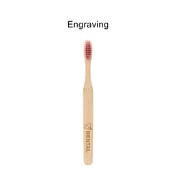 A bamboo toothbrush with a large flat handle and pink bristles, featuring a logo on the handle.