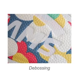 A close-up view of the textured surface of a PU basketball, featuring vibrant red, yellow, green, and blue patterns.