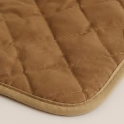 A medium quilted pot holder in a warm brown shade with a stitched pattern and contrasting border.