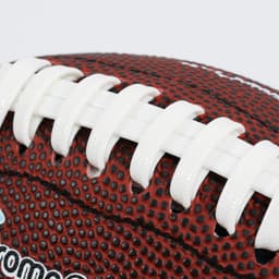 A mini promotional American football in red and white, featuring textured detailing and a logo.