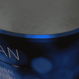 A blue oval popup booth with a smooth, dark top surface, featuring an abstract design.
