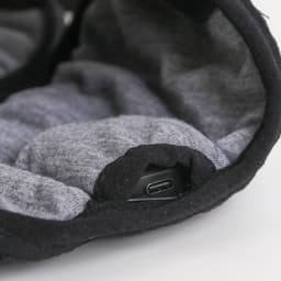 A pair of Bluetooth sleep headphones in black and grey, featuring a USB-C charging port.