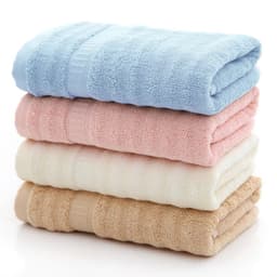 A stack of bamboo fiber towels in blue, pink, cream, and beige, neatly folded with a textured design.