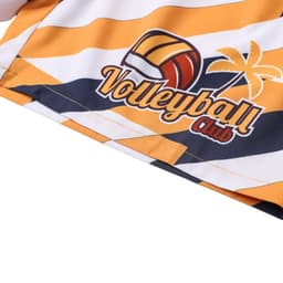 A pair of women's board shorts in yellow and white with a volleyball graphic and palm tree design. Features a drawstring and pocket.