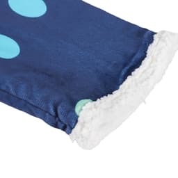 A soft, navy blue blanket with large light blue polka dots and a fluffy white edge, featuring a branding logo.