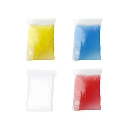 Four plastic bags contain coloured powders: yellow, blue, white, and red, each with a glossy finish.