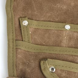 A brown garden tool waist pouch featuring multiple pockets and reinforced edges with green straps.