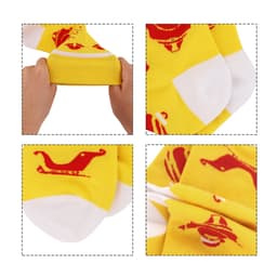 Bright yellow woven socks featuring playful red patterns, shown being stretched and folded. Includes a logo detail.