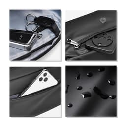 A black fanny pack features a keychain, a slot for a phone, and shows water droplets on the surface. It has a logo present.