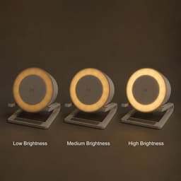 A night light speaker with a wireless charger displayed at low, medium, and high brightness settings, in white.