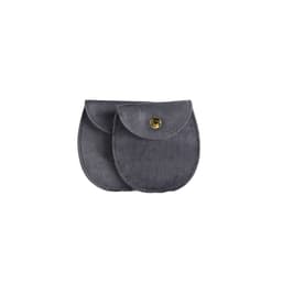 A grey oval velvet jewelry pouch featuring a snap button closure and a soft texture. It has a logo.