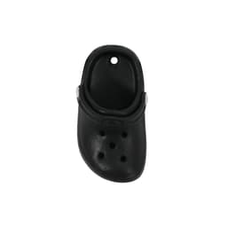 A black clog shoe fridge magnet featuring ventilation holes and a strap, with a circular hole at the top.