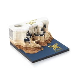 A 3D paper carving notepad in cream and blue featuring an intricate castle design atop a layered landscape.