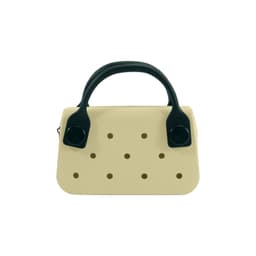 A mini handbag in cream with black handles and ventilation holes. It features a simple, modern design.