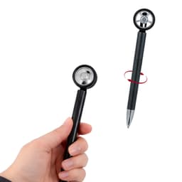A black fidget spin tire-shaped pen being held in a hand, featuring a shiny spinning wheel design.