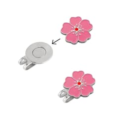 A custom soft enamel golf ball marker in pink, featuring a flower design with a silver attachment.