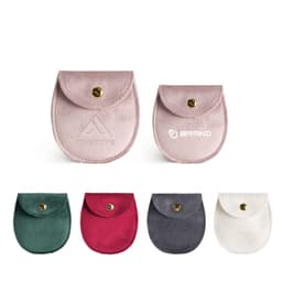 Oval velvet jewelry pouches in various colours: pink, green, burgundy, grey, and white, featuring a snap closure and branding.