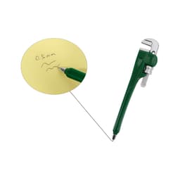 A green pipe wrench-shaped ballpoint pen rests next to a yellow notepad with handwritten notes.