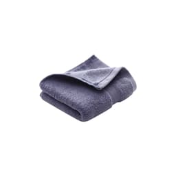 A folded embroidered cotton hand towel in a deep blue colour with a textured finish. Features a logo.