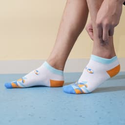 Low cut custom pattern socks in white, blue, and orange with a colourful design, featuring a logo on the side.