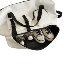 A white travel weekender bag with black straps, featuring sneakers and drink bottles inside. It has a pocket on the side.