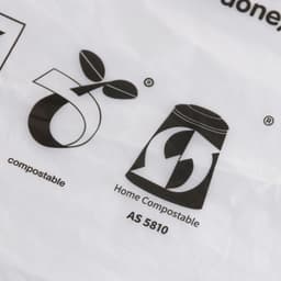 A clear, biodegradable self-adhesive bag featuring eco-friendly symbols and a logo.