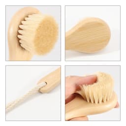 A natural wooden face brush in light wood with soft bristles, featuring a rope handle.