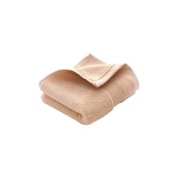 A folded beige cotton hand towel with a textured surface, featuring a logo on the side.