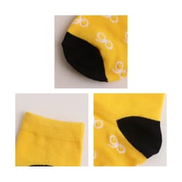 Yellow woven bamboo socks featuring a black heel and toe, with a repeating white pattern, alongside a logo.