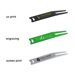 A set of three golf divot tools in black, green, and silver, each featuring a different brand logo or engraving.