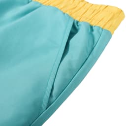 A pair of men's beach shorts in teal with a yellow elastic waistband and a side pocket.