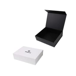 A black foldable magnetic box is partially open beside a white box with a logo. Both are designed for packaging.