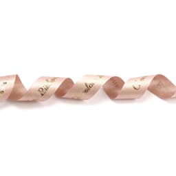 A satin ribbon in glitter gold and soft pink tones, featuring a wavy design and a logo.