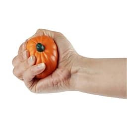 An orange pumpkin-shaped stress reliever being squeezed by a hand, featuring a smiling face design.