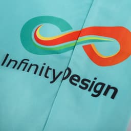 A pair of turquoise beach shorts featuring a colourful logo and branding.