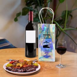 A PVC laser wine ice bag in iridescent colours next to a bottle of red wine and a plate of food on a wooden table.