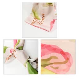 A Twill Weave Long Scarf featuring floral patterns in pink and green hues, with a subtle logo visible.
