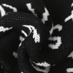 Acrylic fibres scarf featuring a black and white design, showcasing a textured knit pattern.