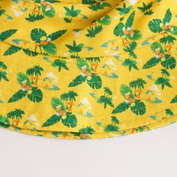 A yellow RPET bucket hat featuring a tropical leaf and floral pattern, with a logo detail.