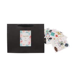 A large black paper bag with a fabric handle, accompanied by various decorative stickers.