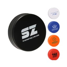 A black hockey puck shape stress reliever with a logo, accompanied by blue, orange, and red stress relievers.